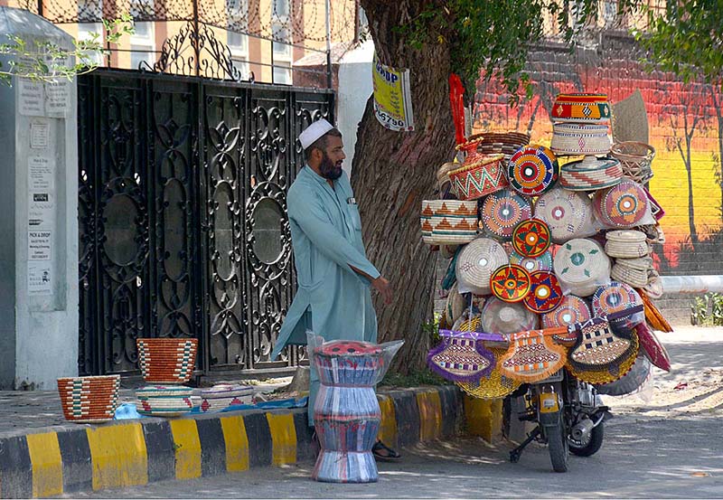 A street vendor displaying traditional household items on his bike