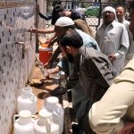 People filling drinking water from filtration plant at Ghori town during hot day in the Federal Capital