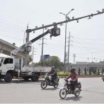 A worker is repairing CCTV cameras during maintenance work in Federal Capital