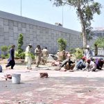 Workers working on 9th Avenue Flyover at IJP Road during development work in the city