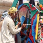 Artisan painting on a delivery truck at Bahawalpur bypass
