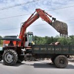 CDA worker removing the sacrificial animal waste from the street on the 2nd day of Eid Ul Azha.