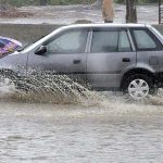 Commuters faces a challenging task of crossing stagnant water amidst heavy rainfall at IJP road