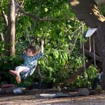 Little girl enjoy swing outside her house at outskirts of the Federal Capital