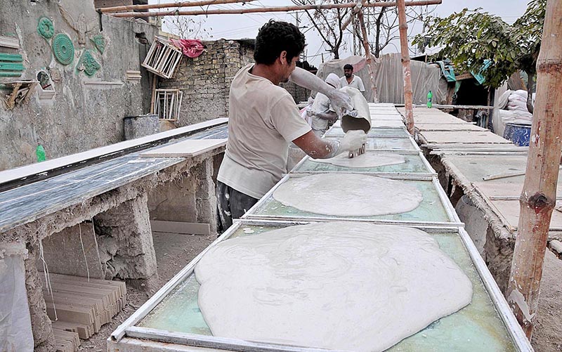 Labourer making ceilings to be used in the houses at Khyban-e-Sir Syed