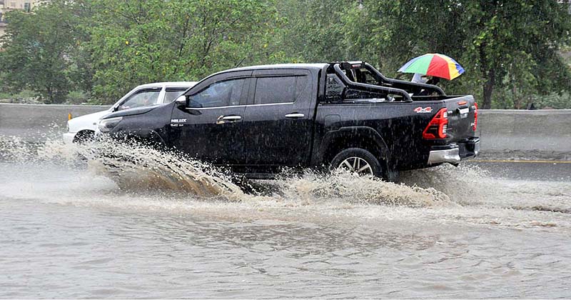 Commuters faces a challenging task of crossing stagnant water amidst heavy rainfall at IJP road