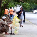 A street vendor displaying balloons to attract customers at Jinnah Super Market