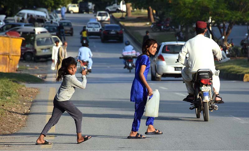 Little girl enjoy swing outside her house at outskirts of the Federal Capital