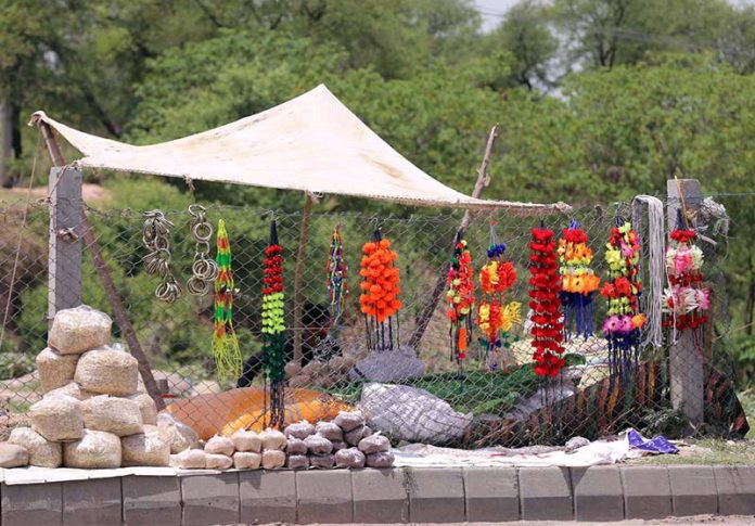 A vendor displaying ornaments of sacrificial animals to attract customers at Ghouri Town
