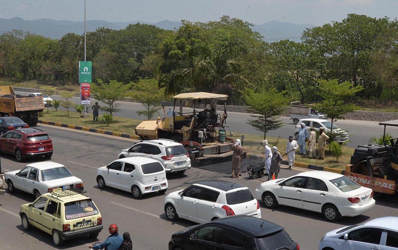 CDA staffers busy in patches work on Express way near parade ground during maintenance work
