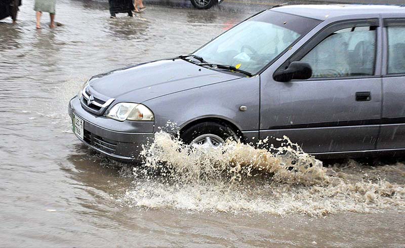 Commuters faces a challenging task of crossing stagnant water amidst heavy rainfall at IJP road