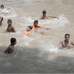 Youngsters enjoying in the canal to get relief from the hot weather