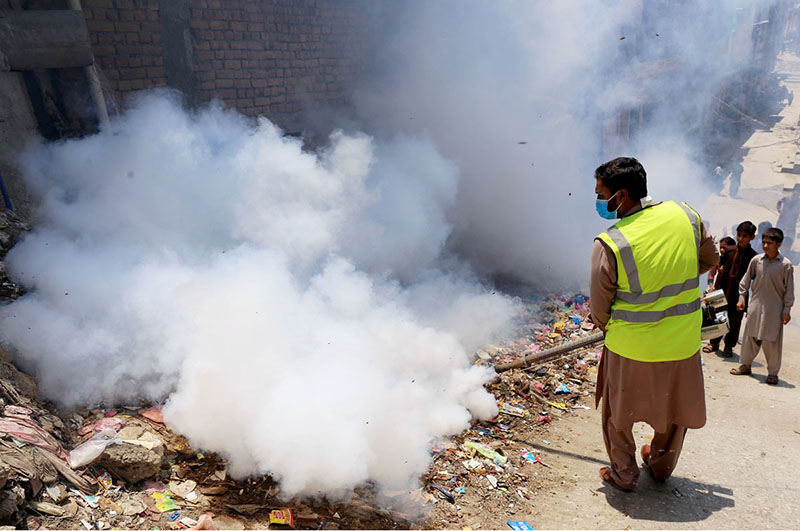 Health workers spraying anti dengue spray in the residential areas to protect from dengue fever at Pirwadhai neighbourhood