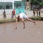 Youngster jumping into the canal to get some relief from hot weather in the city