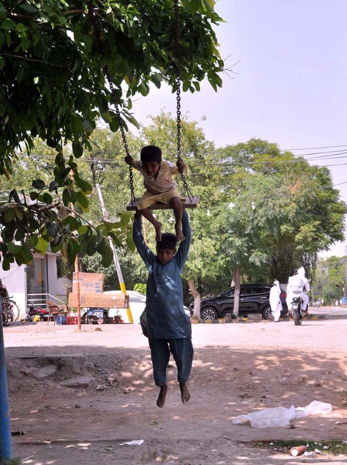 Gypsy children enjoy swings near club Road