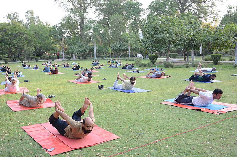 People are doing yoga exercise to keep themselves healthy and stress free on the World Yoga Day at Bagh-e-Jinnah