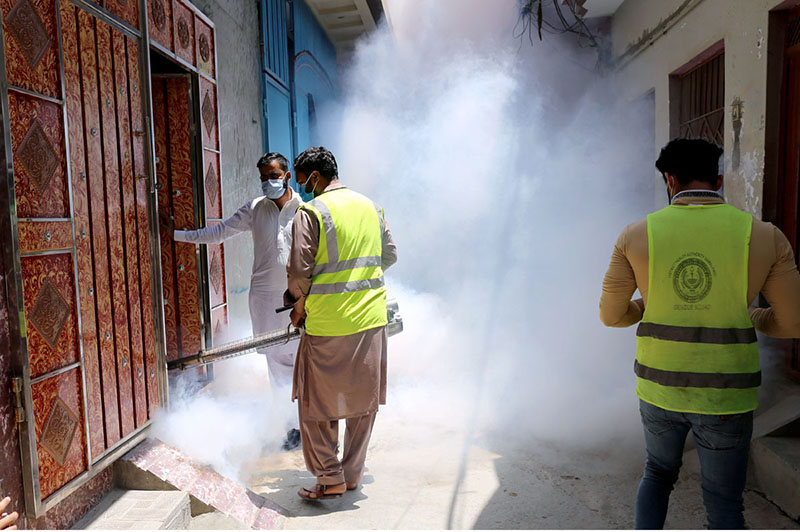 Health workers spraying anti dengue spray in the residential areas to protect from dengue fever at Pirwadhai neighbourhood