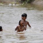 Children are enjoying in the canal to get some relief from the hot and humid weather