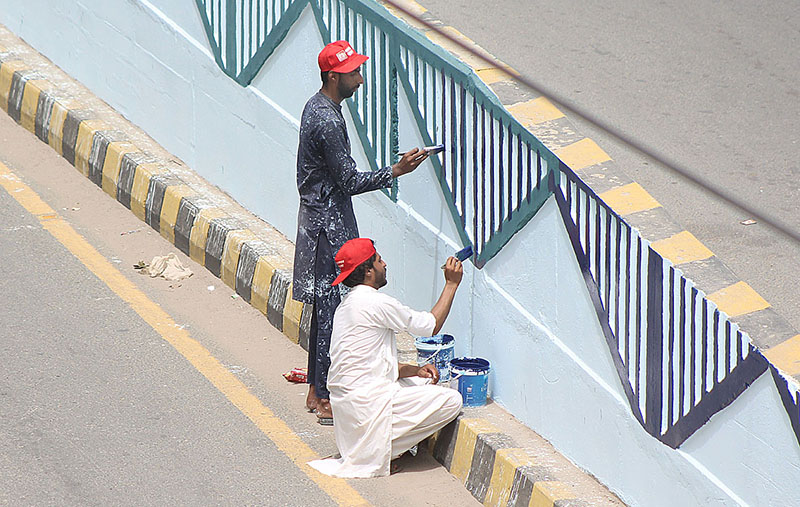 Workers are painting on the Kalma Chowk Flyover