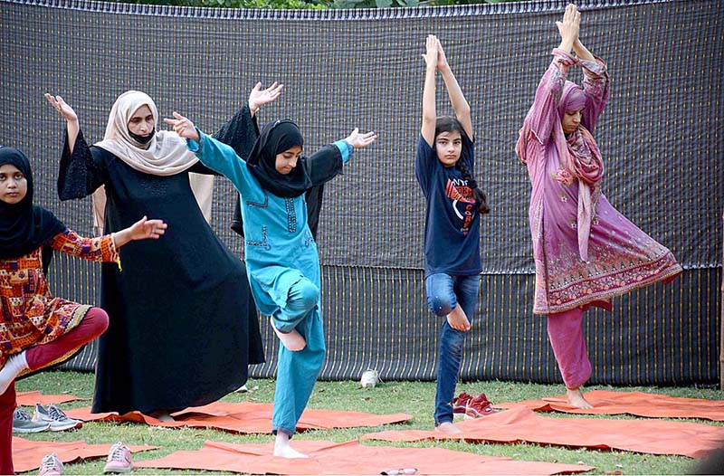 People are doing yoga exercise to keep themselves healthy and stress free on the World Yoga Day at Bagh-e-Jinnah
