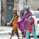 Gypsy women on their way to sell collected meat on the 2nd day of Eid ul Adha at Jamia Masjid Road