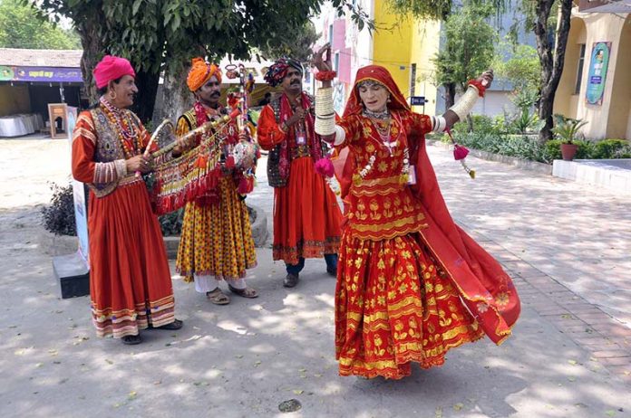 Artists performing cultural dance during Saqafati Mela promoting Pakistani culture providing entertainment to public at Lok Virsa