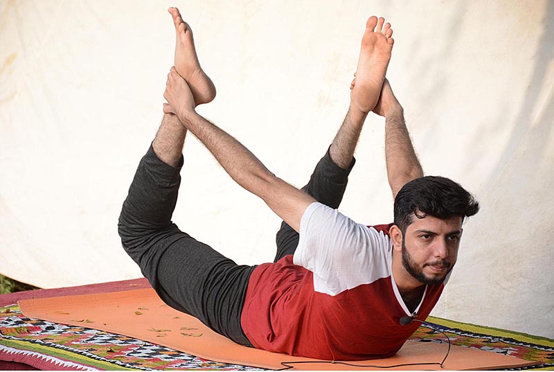 People are doing yoga exercise to keep themselves healthy and stress free on the World Yoga Day at Bagh-e-Jinnah