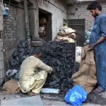 A vendor selling coal to customers as demand increased for upcomming Eid ul-Azha