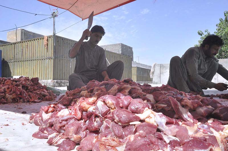 Butchers are cutting meat into pieces after sacrificing animals on the 2nd day of Eid Ul Azha at I-9.