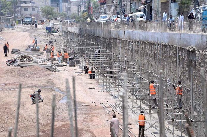 Labourers are busy in construction work of Sumanabad Underpass during development work in Provincial Capital