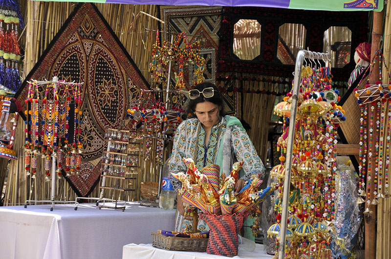 Artists performing cultural dance during Saqafati Mela promoting Pakistani culture providing entertainment to public at Lok Virsa