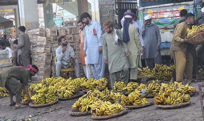 Traders selling seasonal fruit bananas to the vendors at the Fruit Market