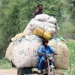 A person riding an overloaded tricycle rickshaw which may cause any mishap