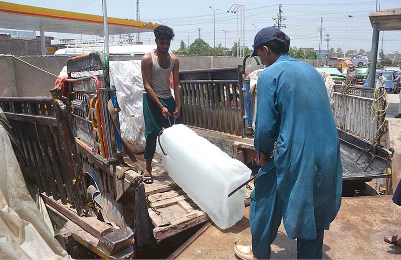 Laborers are loading ice blocks to a delivery van at G.T Road
