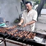 A person roasting barbecue on the 2nd day of Eid Ul Azha at INPC.
