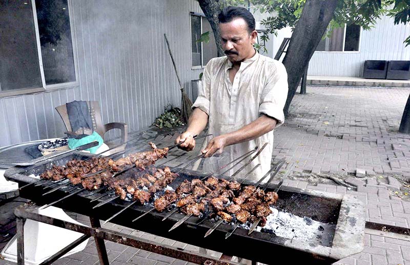A person roasting barbecue on the 2nd day of Eid Ul Azha at INPC.