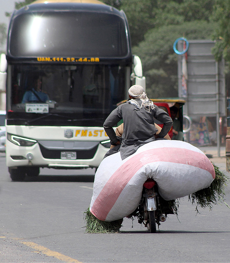 A person riding an overloaded tricycle rickshaw which may cause any mishap