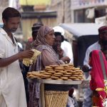 Vendor Displaying handmade Biscuits to Attract the Customer at Roadside