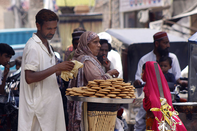 Vendor Displaying handmade Biscuits to Attract the Customer at Roadside