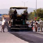 Heavy machinery being used to repair a road near Faizabad interchange in the Federal Capital