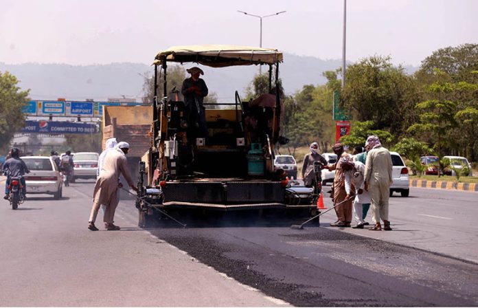 Heavy machinery being used to repair a road near Faizabad interchange in the Federal Capital