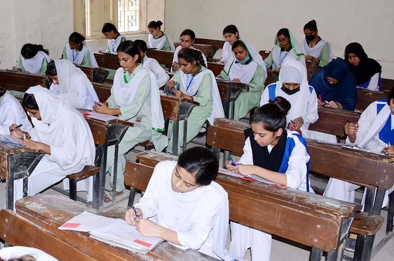 Students solving question paper during annual examination of HSSC (Part-II) at Government Degree Girls College at Latifabad