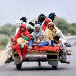 A gypsy family traveling on tricycle cart on Khairpur Road