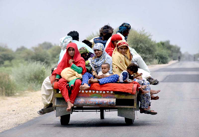 A gypsy family traveling on tricycle cart on Khairpur Road