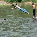 Youngster enjoys jumping and bathing in rawal lake to beat the heat at Federal Capital
