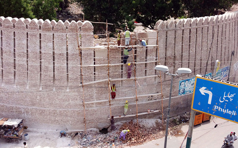 Workers repairing the wall of the historical Pakka Fort to restore by Heritage Department at Station Road