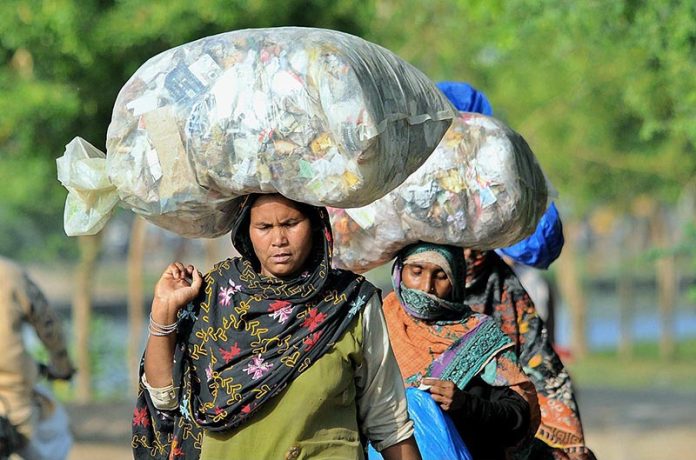 Ladies on the way back carrying huge bundles on their heads