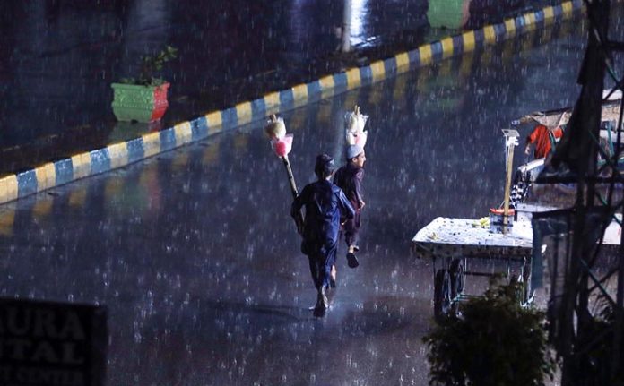 People on the way making their journey during rain in the Federal Capital that experienced in twin cities on Tuesday late night