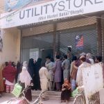 People standing in a queue waiting their turn outside Utility Store to purchase grocery items on subsidized rates at Masoom Shah Road