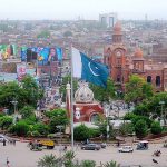 A view of the Clock Tower Chowk, with its bustling traffic and vibrant surroundings